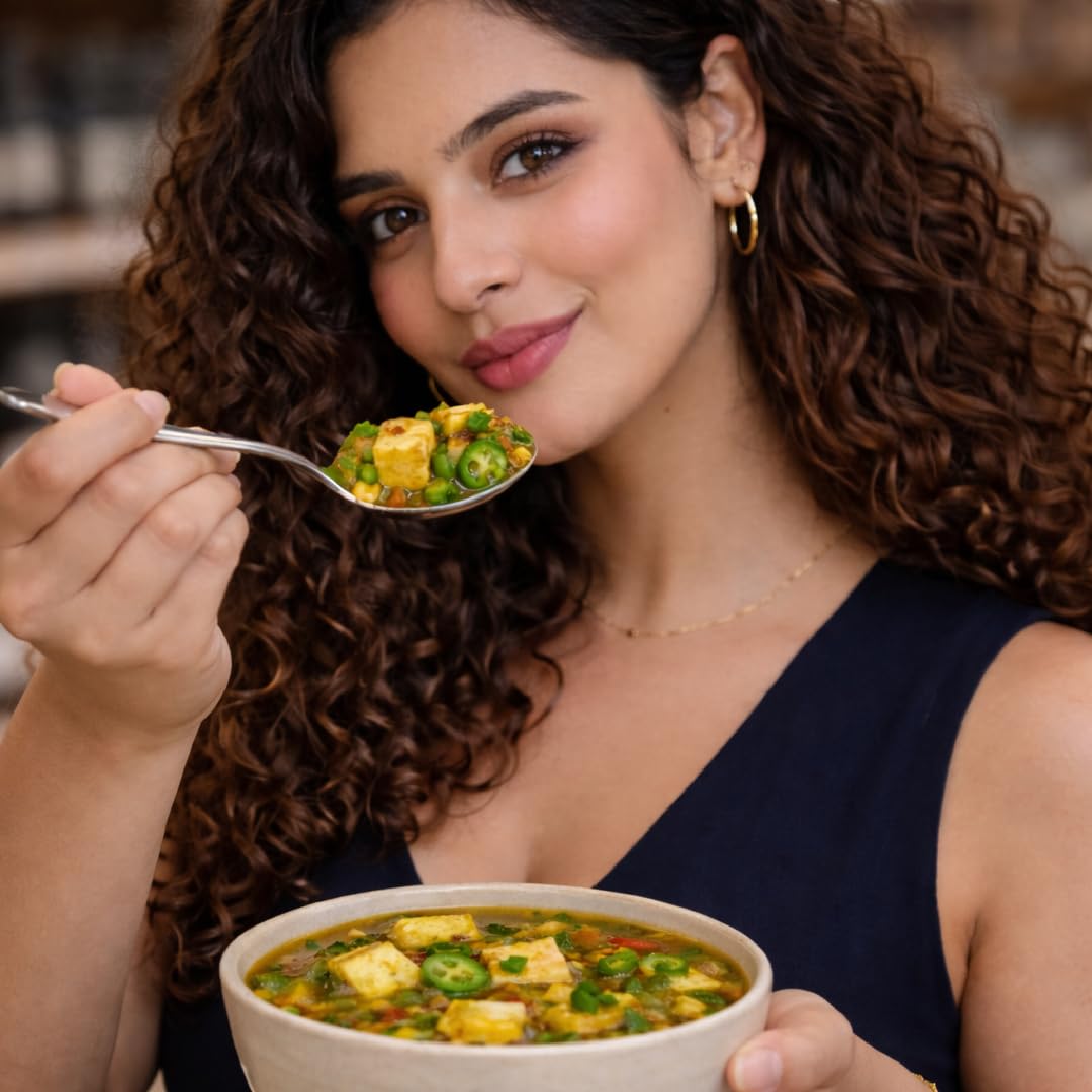 Enjoying a bowl of Kuddle Super Meal with paneer and vegetables